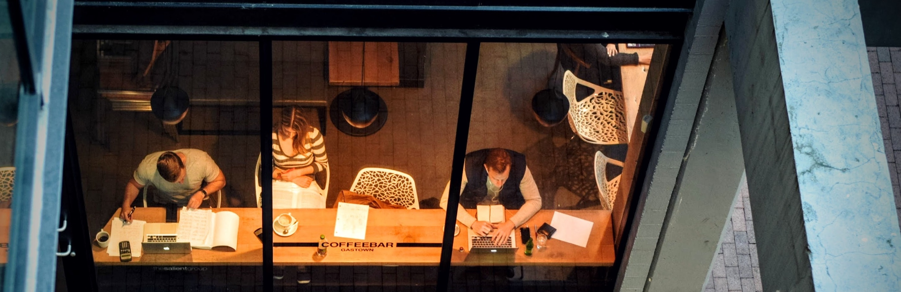 An image of people through the front window of a cafe.